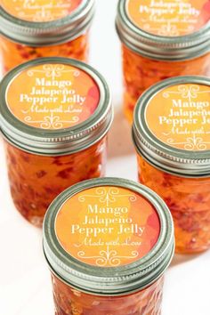 four jars filled with food sitting on top of a table