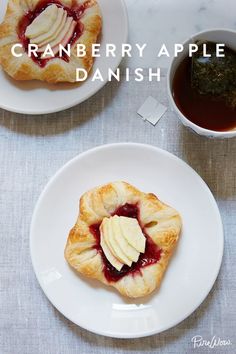 cranberry apple danish on a white plate next to a cup of tea and sauce