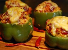 green peppers stuffed with cheese and chili on a cutting board