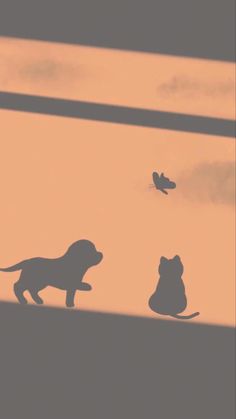 the silhouettes of two dogs and a cat are shown against an orange sky
