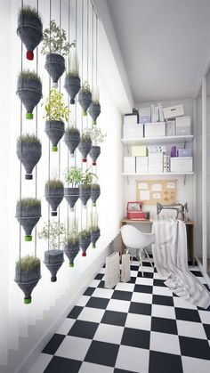 a black and white checkered floor with potted plants hanging from the wall in front of it