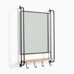 a wall mounted mirror and shelf with hooks