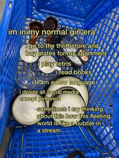 a blue shopping cart filled with lots of white plates and bowls next to words describing how i'm in my normal girl - era