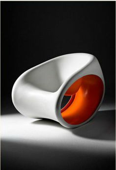 a white chair with an orange light in it's center on a black background