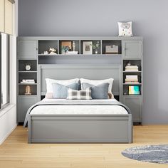 a bed sitting in a bedroom next to a book shelf