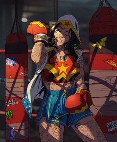 a woman in a costume standing next to two boxing gloves and punching mitts with her right hand