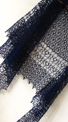 a piece of blue lacy fabric on a white surface