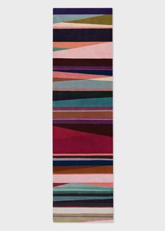 a multicolored rug with stripes on it