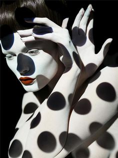 a woman with black and white polka dots on her body