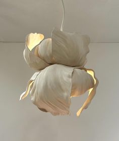 a white flower is hanging from the ceiling