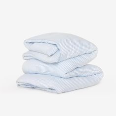 three blue and white striped sheets stacked on top of each other
