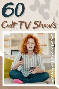 a woman with red hair is sitting on the floor and holding a remote control in her hand