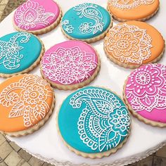 decorated cookies are arranged on a white platter