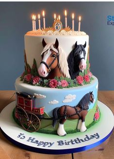 a birthday cake with two horses on it and candles in the shape of horse heads