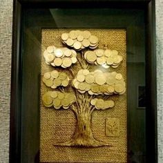 a tree made out of coins in a frame