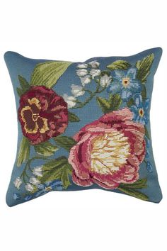 a blue pillow with flowers on it