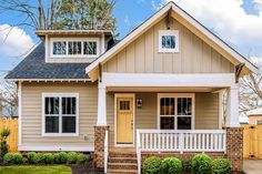 a gray house with white trim and windows