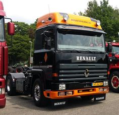 two large trucks parked next to each other in a parking lot