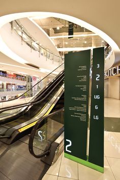 an escalator in the middle of a shopping mall