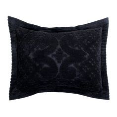 two black decorative pillows sitting on top of each other