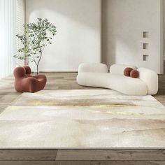 a living room filled with furniture and a plant in the corner on top of a rug