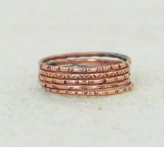 "Order by the end of the day on 11/29 for domestic delivery by 12/24 assuming the USPS does their job. After that I will do my best. Please contact me with any questions Set of 5 Copper Rings, Hand Patterned Rings These rings are Bohemian Chic, Rustic, Understated Luxury. - Delicate stamped Copper - Made to order, just for you. - Choose Antiqued or High Shine (see photos) - Mailed in a cute package suitable for gifting. Handmade completely in my studio each ring is different. This design is pres Boho Stacking Rings, Stacked Rings Boho, Rings Hand, Rings Boho, Measure Ring Size, Dot Ring, Jewelry Appraisal, Pattern Ring, Copper Rings