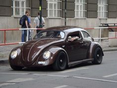 a brown car is parked on the side of the road