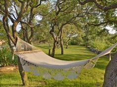 a white hammock hanging from a tree