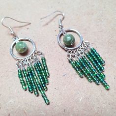 green beaded earrings with silver hoop and dangling beads