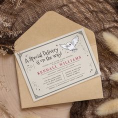 a special delivery is off the way card on top of a piece of wood with feathers