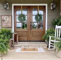 front porch with two rocking chairs and potted plants on the steps to the front door
