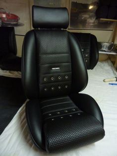 the interior of a car with black leather upholstered seats and headrests