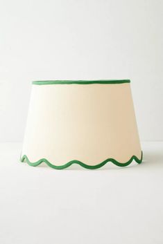 a lamp shade with scalloped edges on a white background