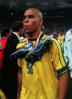 a soccer player is holding his glove in front of the crowd at a sporting event