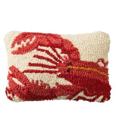 a red and white pillow with a dragon on it