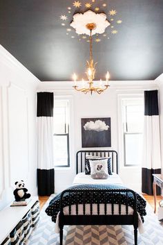 a black and white bedroom with a chandelier