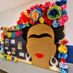 a bulletin board with flowers on it and a woman's face in the center