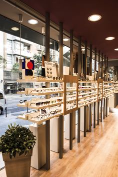 a row of glasses on display in front of a store window with wooden flooring