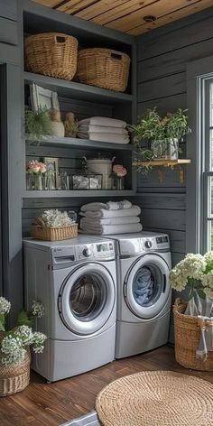 a washer and dryer in a laundry room with baskets on the shelves next to it