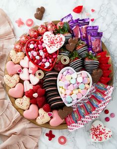 valentine's day treats arranged on a platter with candy hearts and candies