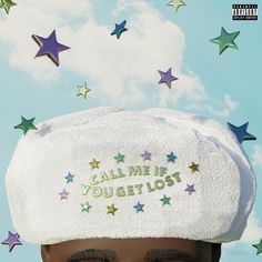 a close up of a person wearing a hat with stars in the sky behind it