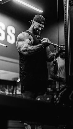 a man standing in front of a gym machine