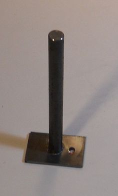 a small metal object on a white surface