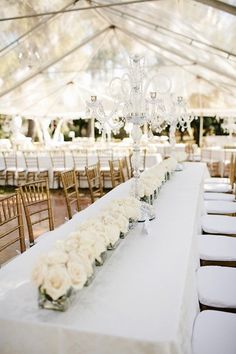 the table is set up with flowers and candles for an elegant wedding reception at modefabrik