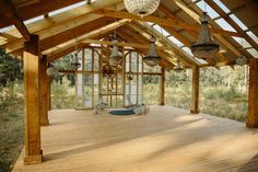 the inside of a wooden building with lots of windows and wood flooring on it