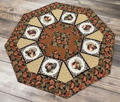 a quilted table topper with pictures of turkeys on it and leaves around the edges