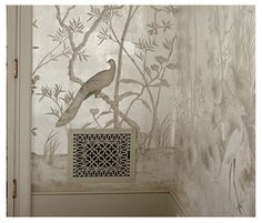 a bird is sitting on a branch in the corner of a room with wallpaper