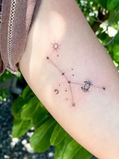 a woman's arm with a small star tattoo on it
