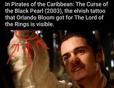 an image of a man holding a baby in his arms and the caption reads, in pirates of the caribbean the curse of the black pearl 2003, the elvis tattoo that orlando bloom got