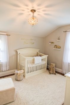 a baby's room with a white crib and teddy bear in the corner